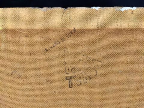 Colour photograph. Close-up detail of a black, triangular ink mark stamped onto a textural brown surface containing text. Although upside-down, the word ‘Royal’ can just be made out. Traces of white paint can be seen on the upper part of the surface.